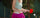 A woman playing table tennis while wearing an ostomy bag.