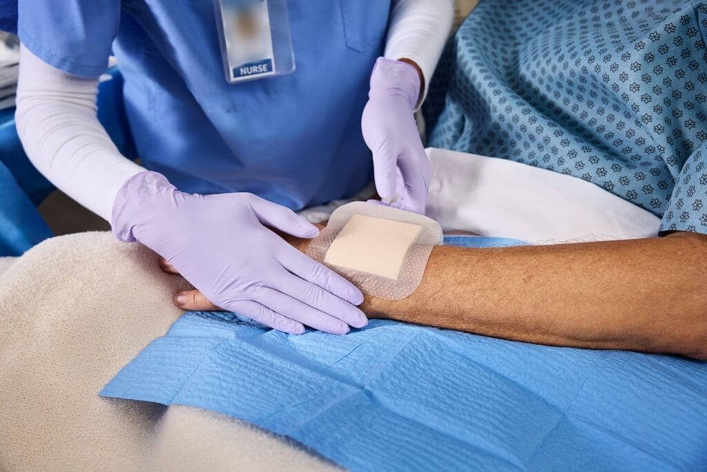 The nurse applied a dressing to the patient.