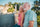 The elderly couple leaned against the stone railing, gazing into the distance, and smiled.