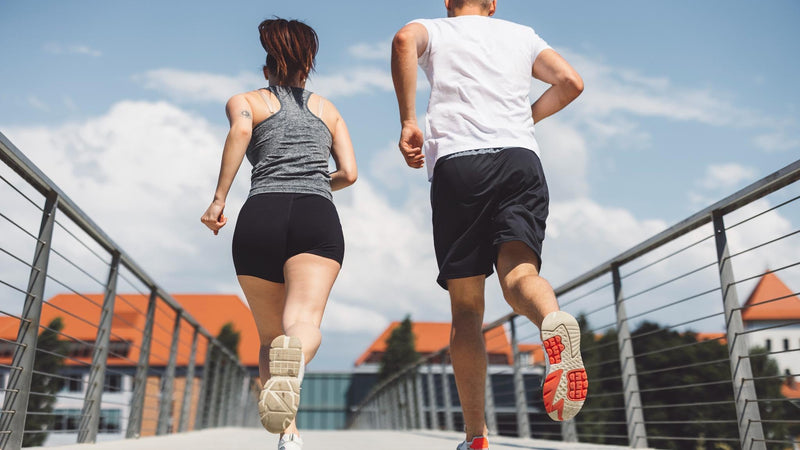 Active lifestyle recovery concept showing runners on bridge after wound healing