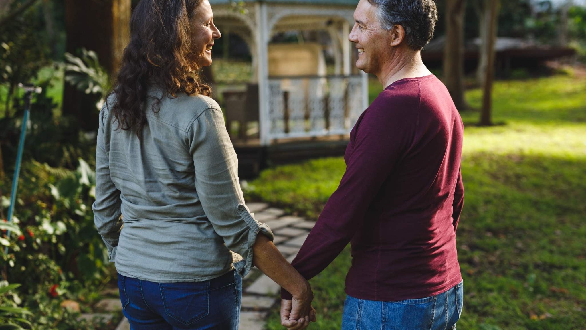 Mature couple holding hands, intimacy and connection after ostomy surgery.